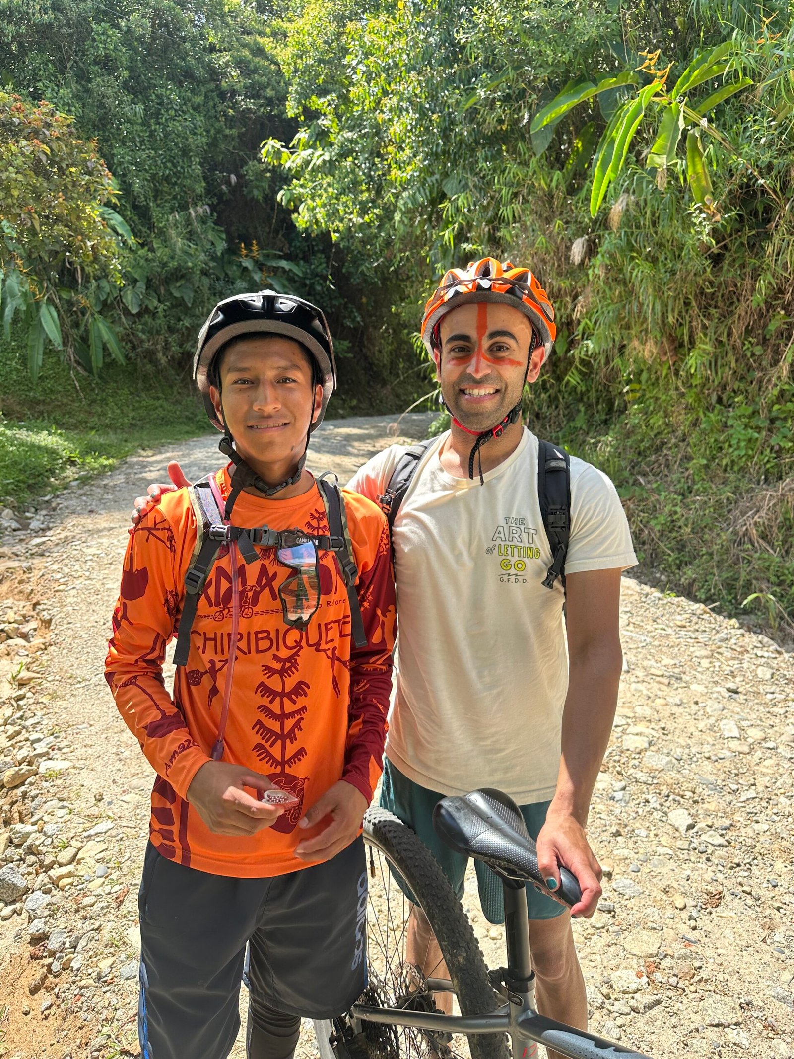 Deivin on mountain bike trail with MBC rider in Colombian highlands