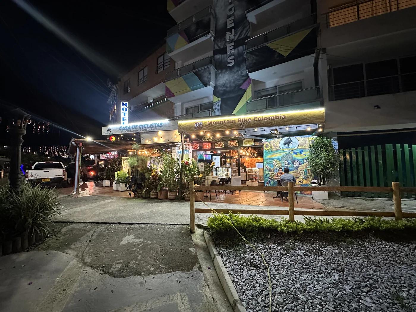 Casa de Ciclistas and Dulce Amazónica at night on the malecón in Guatapé, Colombia